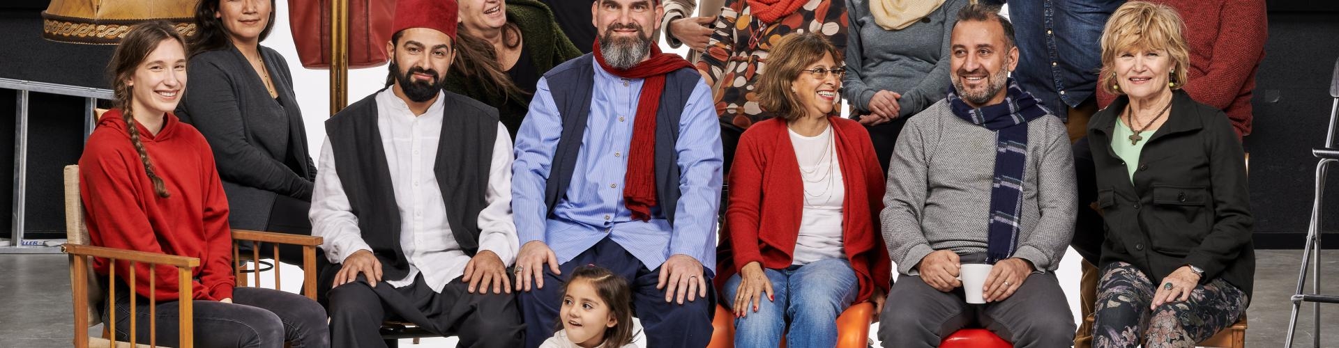 Fröhliche multikulturelle Gruppe posiert in einem Fotostudio vor einer weißen Leinwand